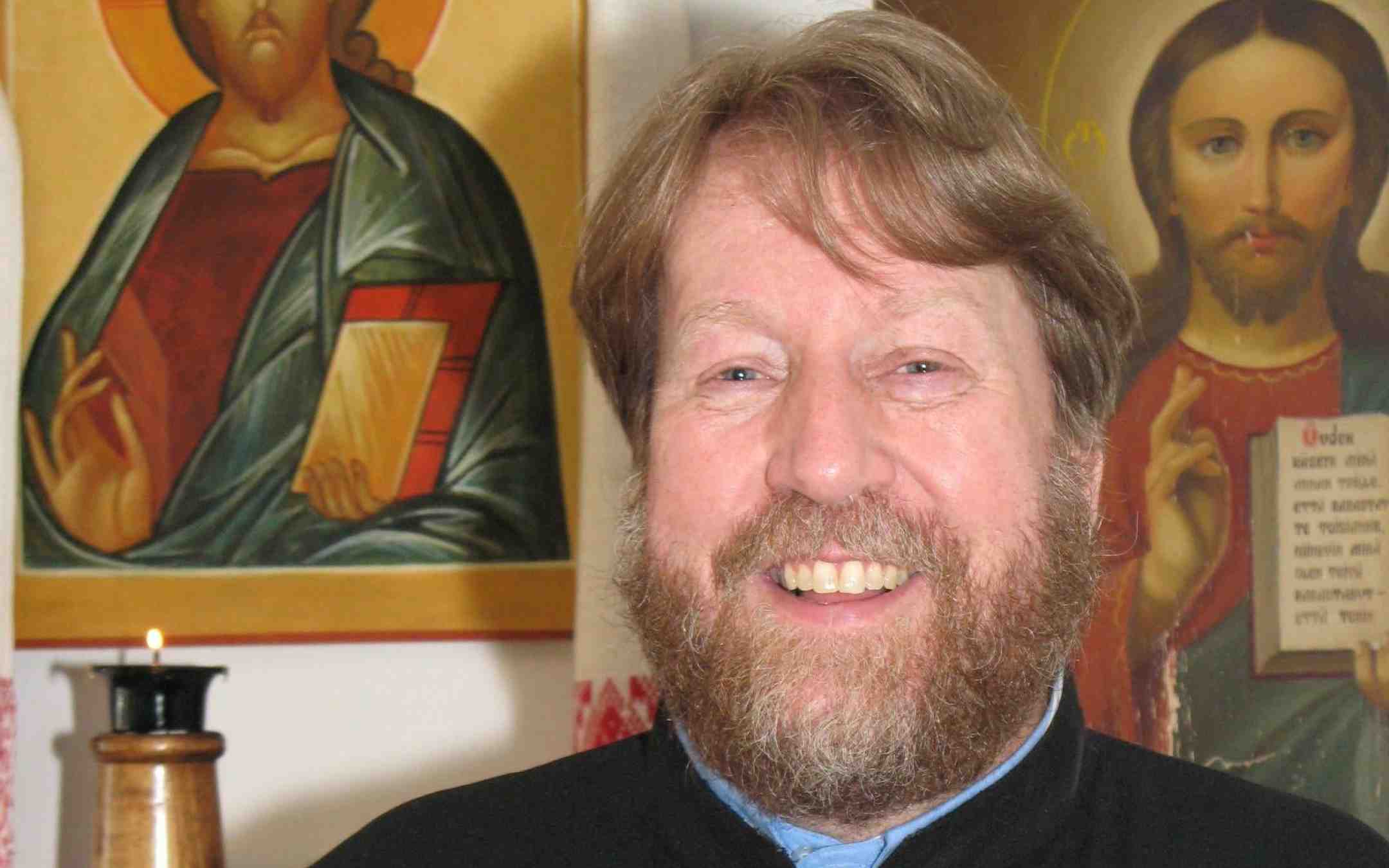 Isä Timo Mäkirinta Jyväskylän ortodoksisesta seurakunnasta lähikuvassa ikoneiden kanssa